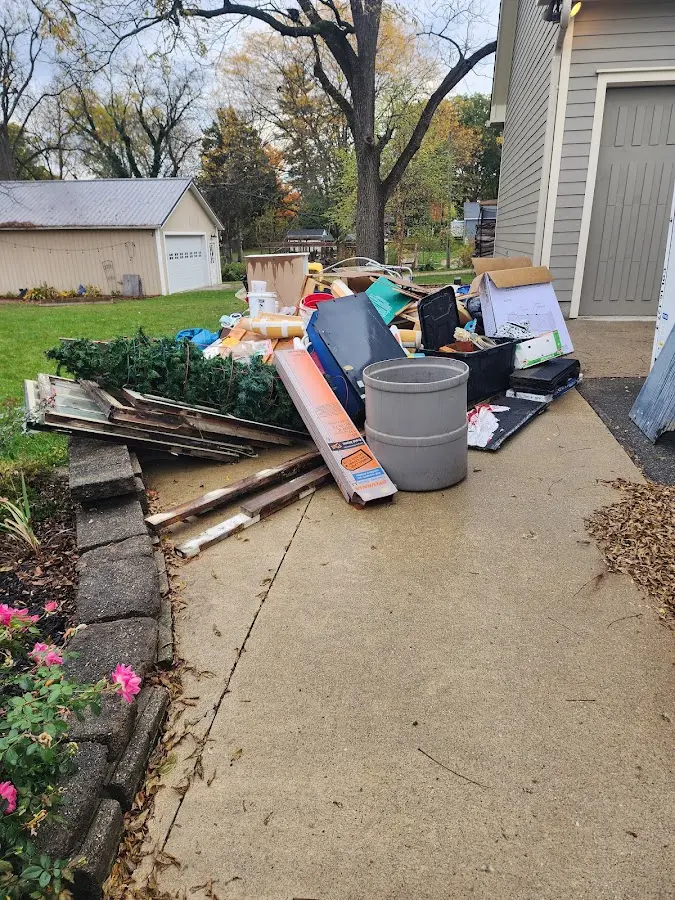 Dumpster being loaded with debris for Commercial Dumpster Rental in Bangor